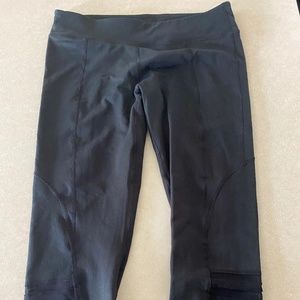 Black capris with mesh design at knee